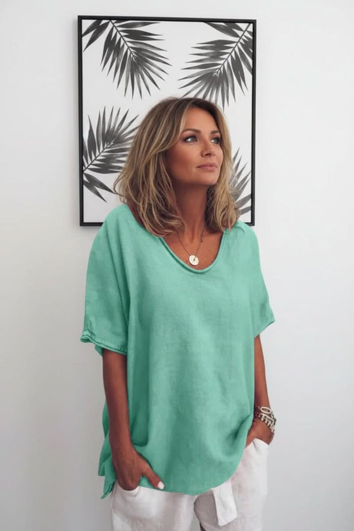 Lightweight women's summer blouse, V-neck, and relaxed fit for breathable, stylish warm weather wear.