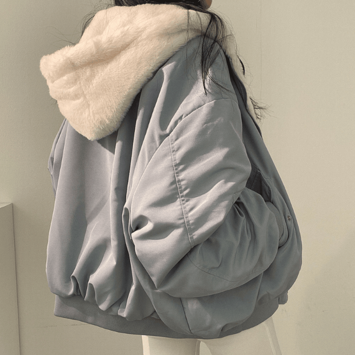 Oversized women's winter coat, sand beige, side view, showing relaxed fit and cozy design.