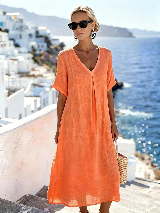 Vacation-perfect women's flowy midi dress, V-neck, short sleeves, relaxed for warm weather.