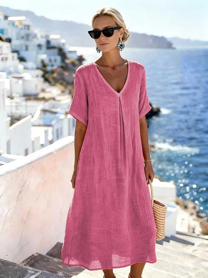 Beach-ready women's short-sleeve midi dress, relaxed V-neck, flowy & comfortable for summer.
