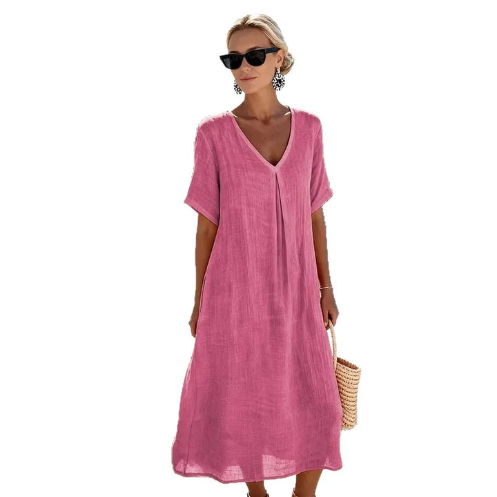 Elegant women's V-neck midi dress with short sleeves, relaxed & flowy for summer days.