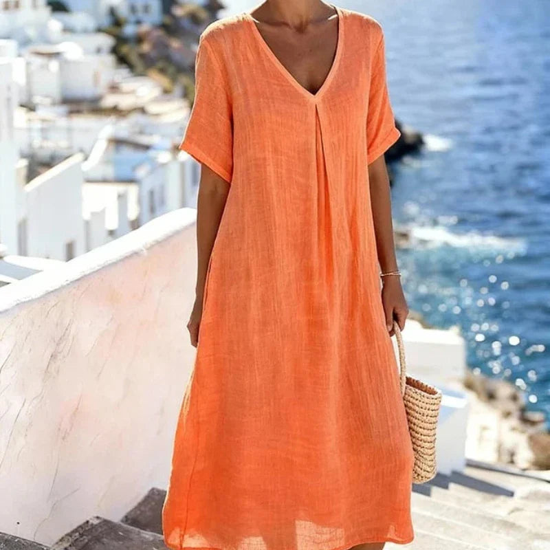 Relaxed fit women's short-sleeve midi dress, V-neck, versatile for casual or beach wear.