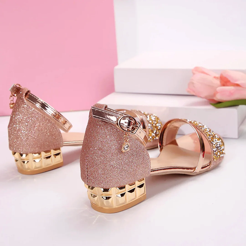 Shimmering women's low block heel party sandals featuring dazzling rhinestones & unique chain ankle strap.