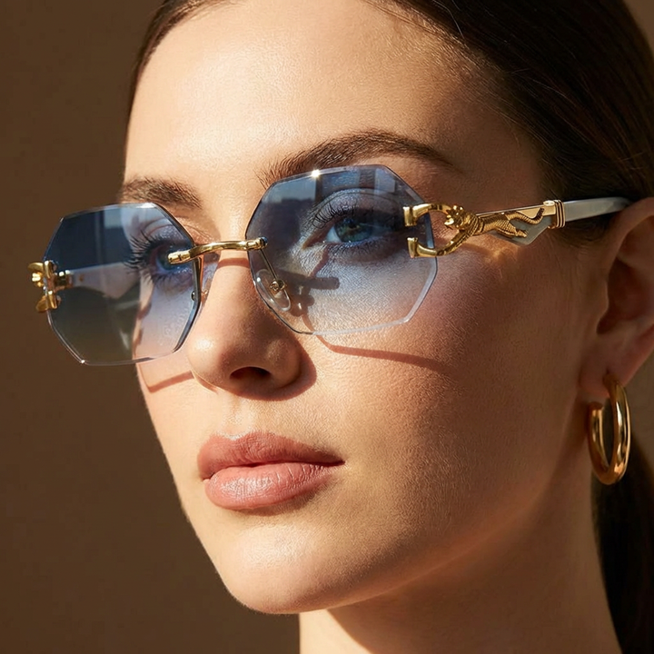 Chic women's geometric rimless sunglasses, featuring unique sculptural gold panther hardware. Statement fashion.