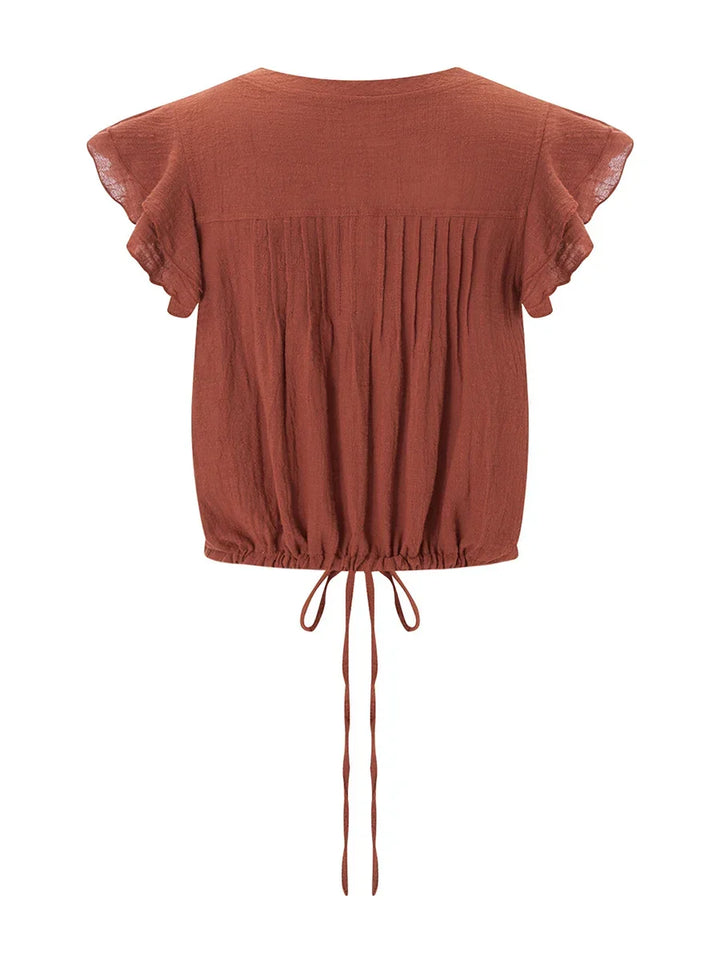 Summer fashion women's ruffle crop top, featuring a flattering cropped fit and flutter sleeves.