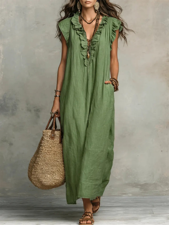 Flowy bohemian ruffle maxi dress for women, featuring a V-neck, flutter sleeves & pockets. Perfect vacation wear.