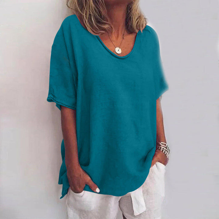 Modern women's loose blouse with a scoop neck and short sleeves, an essential for a comfortable, casual wardrobe.