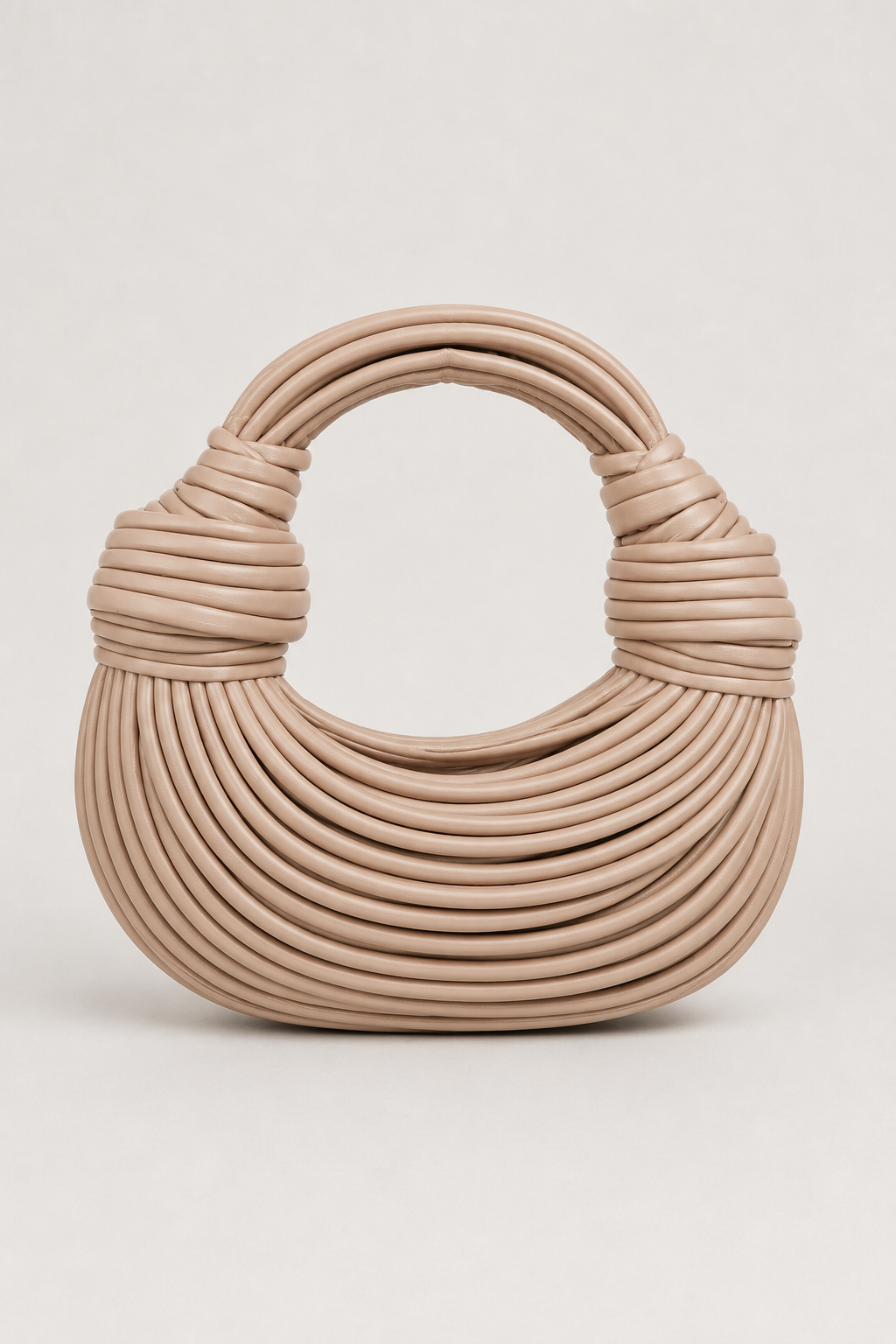 Modern women's shoulder bag: stylish crescent shape with unique loop handle. Elegant and spacious accessory.