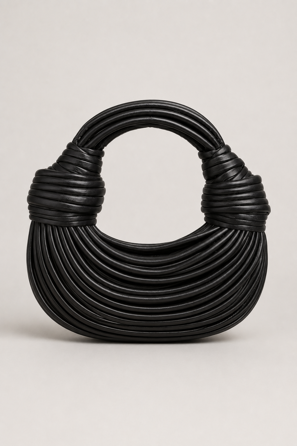 Elegant women's crescent shoulder bag. Sculptural loop handle adds a unique touch to this versatile handbag.
