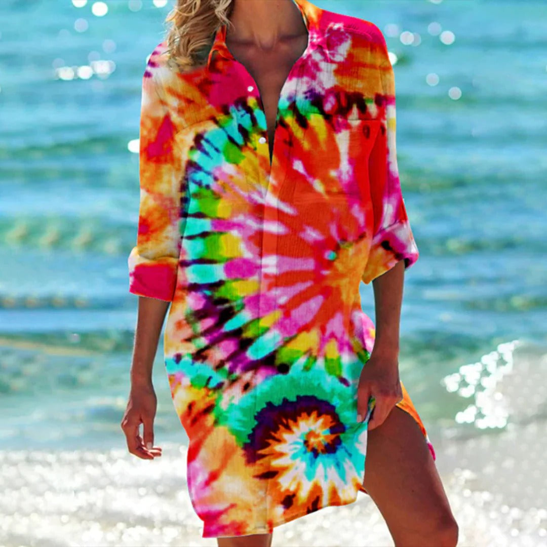 Woman in seashell print 3/4 sleeve beach cover-up shirt dress, enjoying a sunny vacation. Perfect summer outfit.
