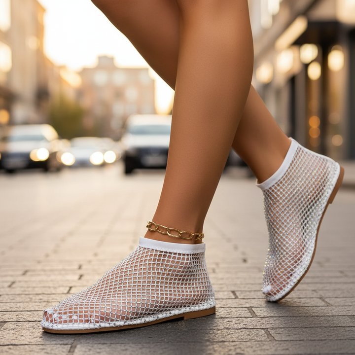 Stylish women's footwear: shimmering rhinestone flats with a secure instep strap. Chic, comfortable, slip-on design.