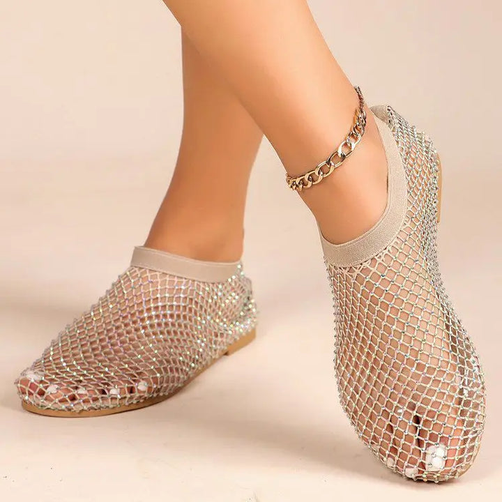 Shimmering women's slip-on flats with dazzling rhinestones, instep strap, and comfortable sole for all-day wear.