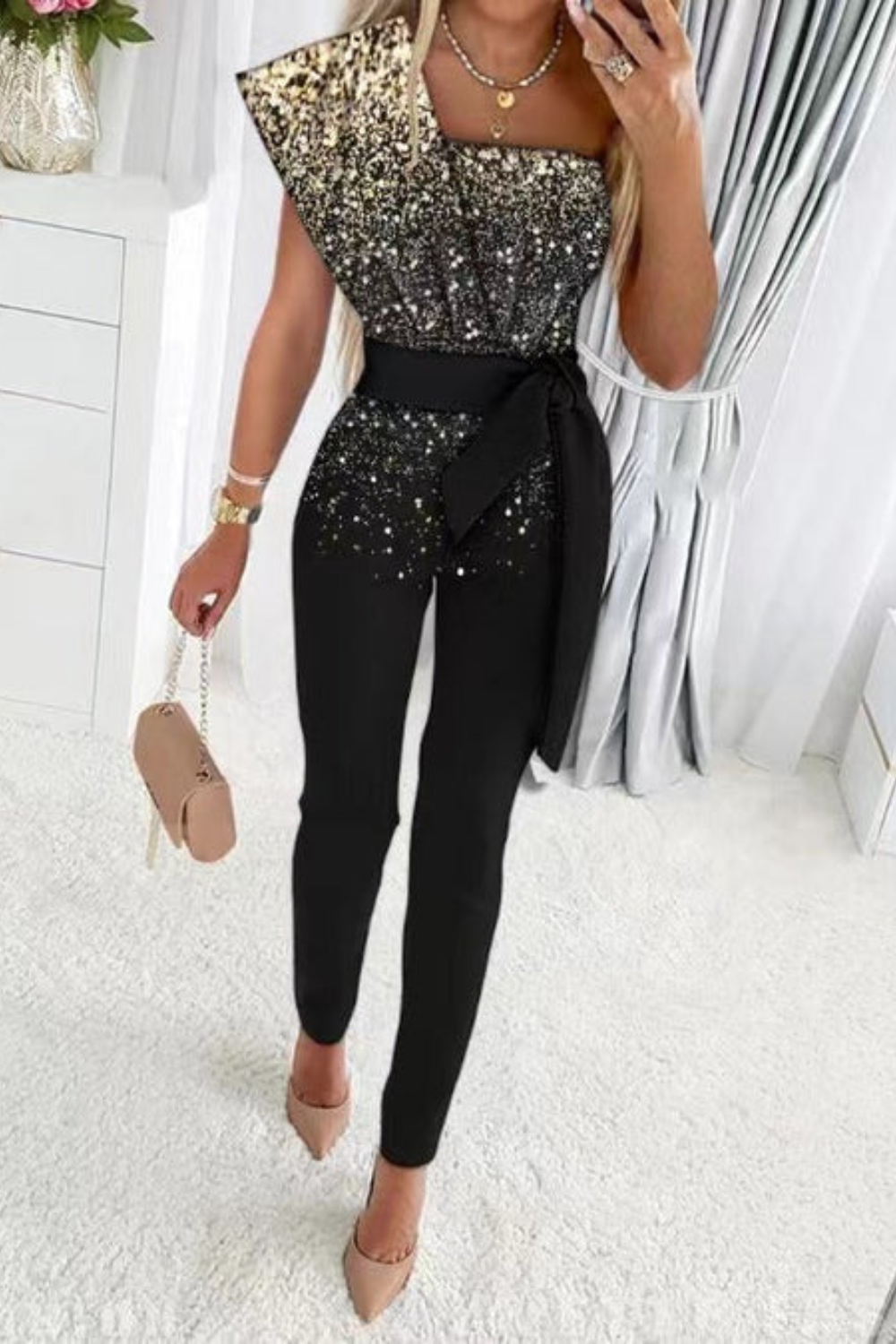 Fashionable women's shimmering sequin jumpsuit for a sophisticated, glamorous evening or party outfit.