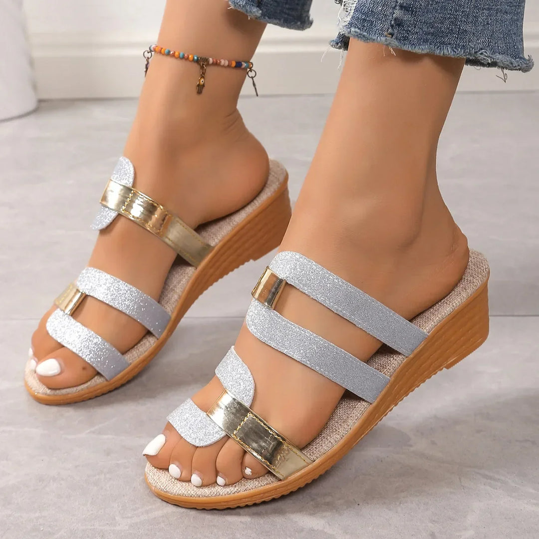 Shimmering triple-strap sandals for women, exuding elegance with their metallic summer design.