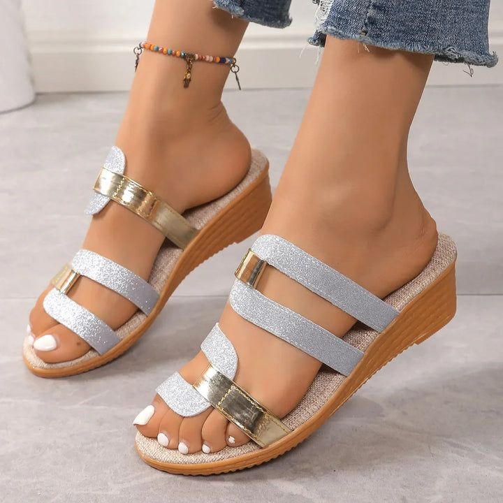 Shimmering triple-strap sandals for women, exuding elegance with their metallic summer design.