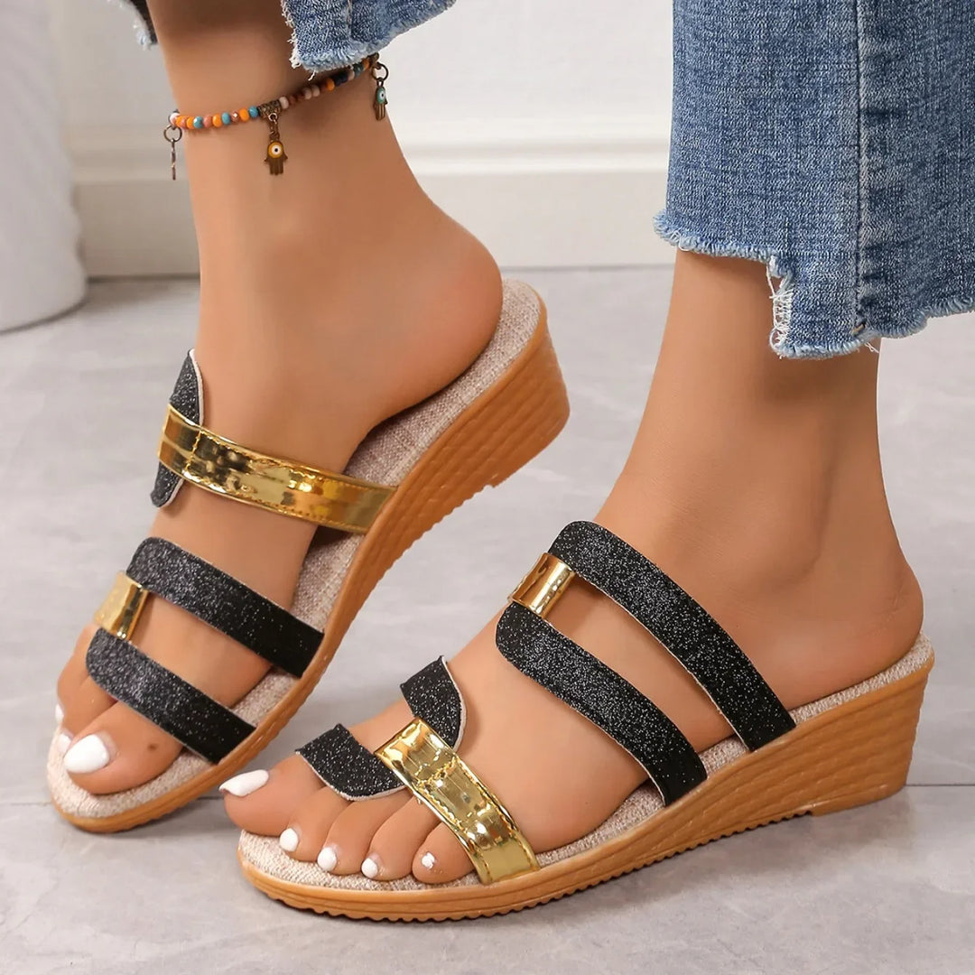 Women's summer footwear: shimmering triple-strap sandals with a touch of metallic sparkle.