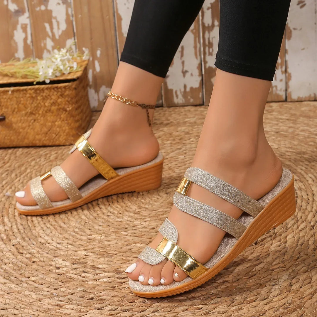 Stylish women's sandals with a shimmery metallic finish and triple strap design for summer.