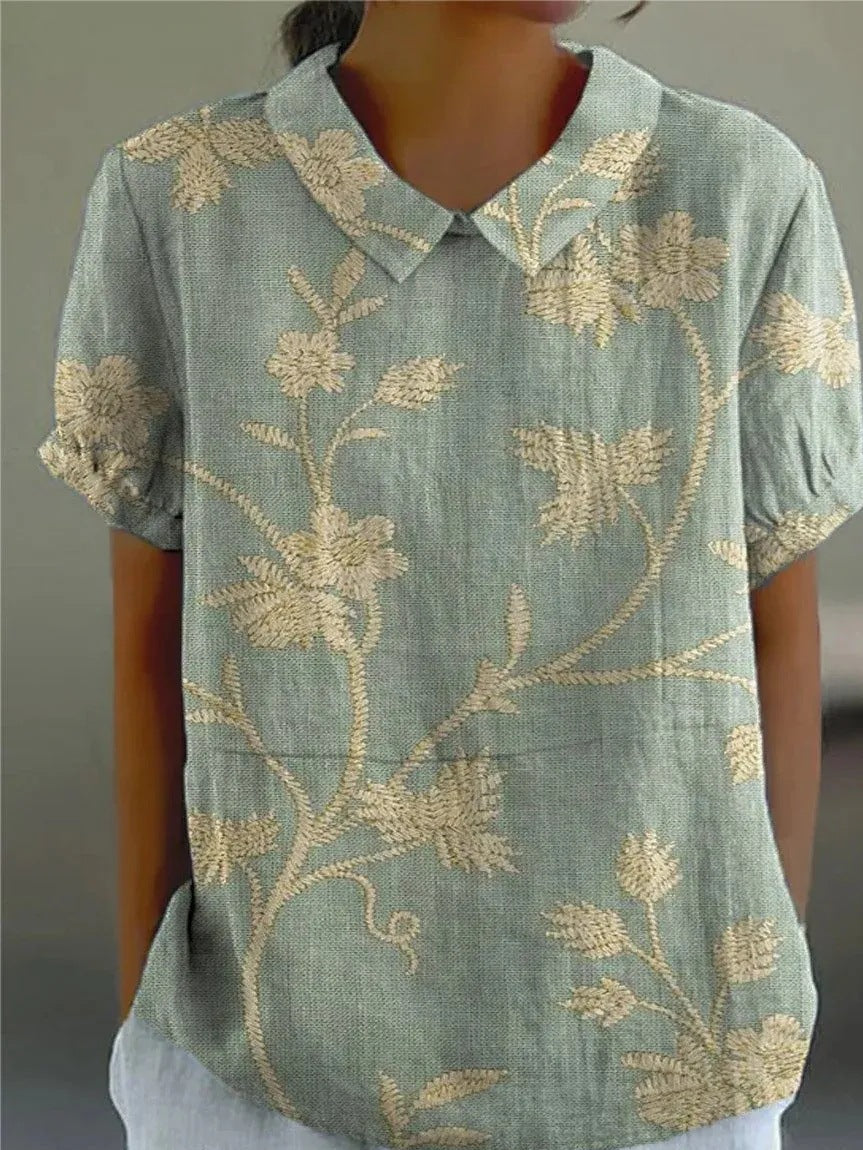 Women's short sleeve blouse with vibrant floral print, perfect for casual spring & summer fashion.