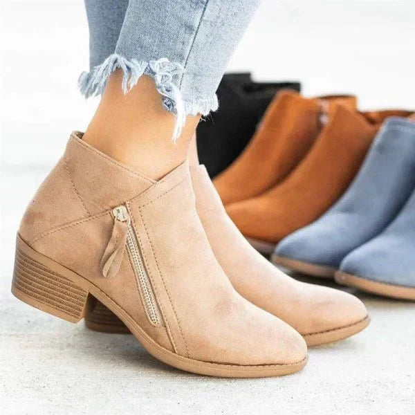 Black women's ankle boots with a comfortable block heel and practical side zip. Perfect for casual outfits.
