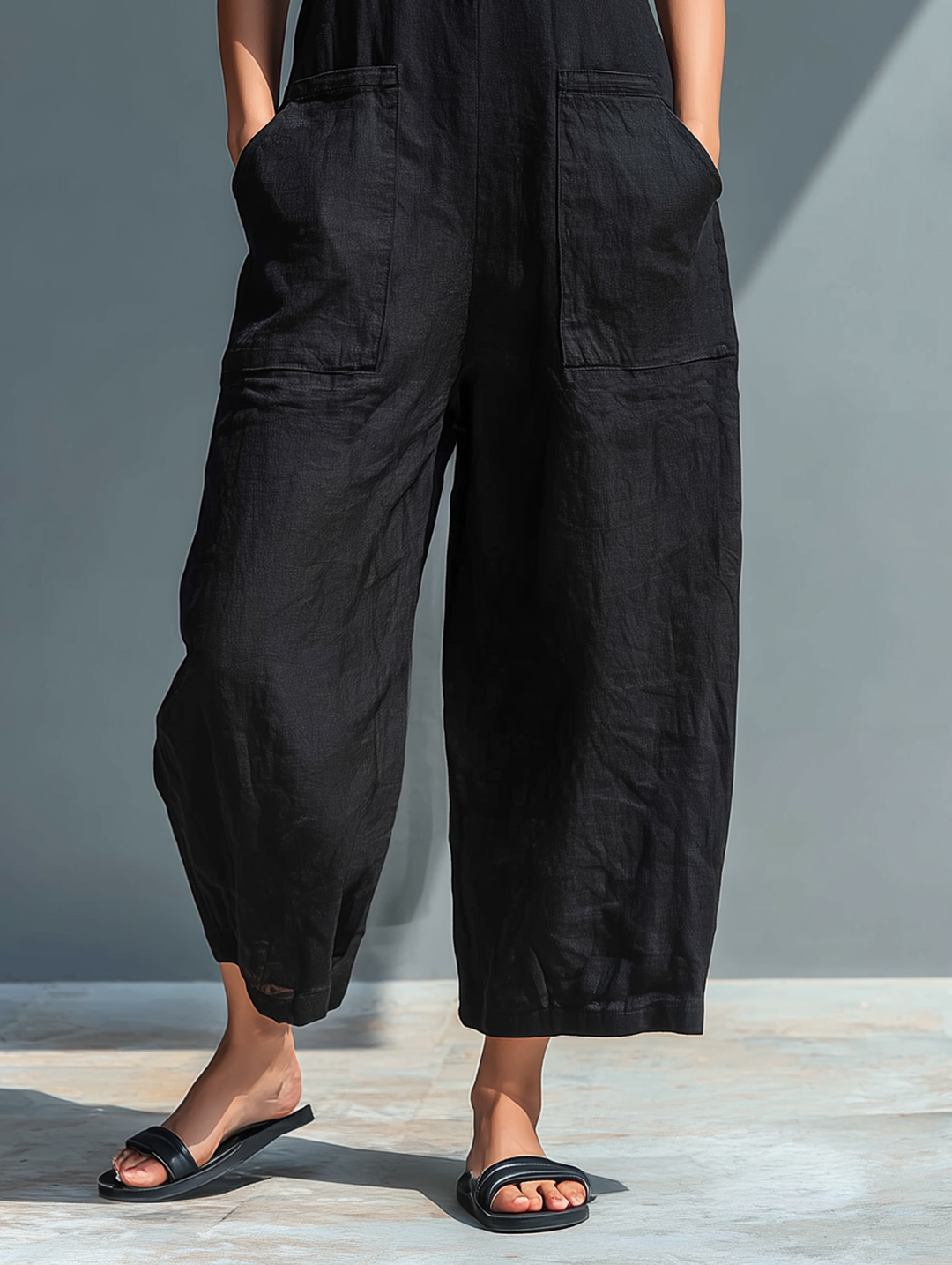 Full-length women's sleeveless jumpsuit, loose fit, button-up, stylish for spring & summer.