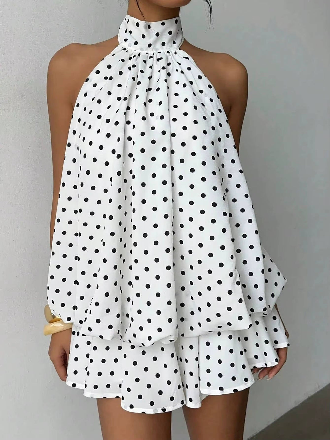 Close-up of the elegant halter neckline on a women's sleeveless mini dress, perfect for chic evening wear.