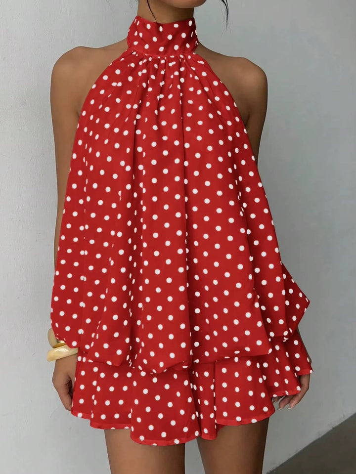 Detailed view of the playful ruffle hem on a women's mini dress, sleeveless halter style, adding movement.