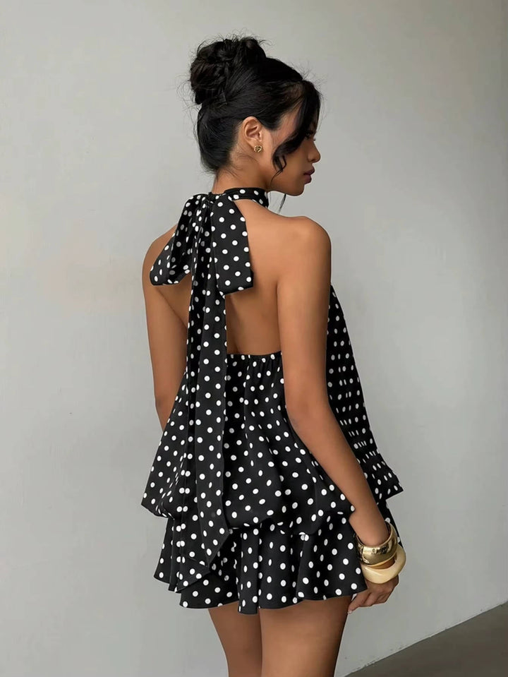 Elegant women's sleeveless halter mini dress, highlighting its sophisticated trapeze silhouette and open back.