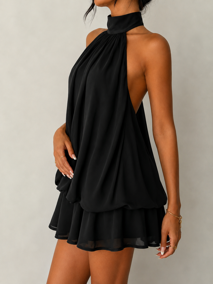Fashion-forward women's halter mini dress, sleeveless, featuring a trendy ruffle hem and eye-catching open back.