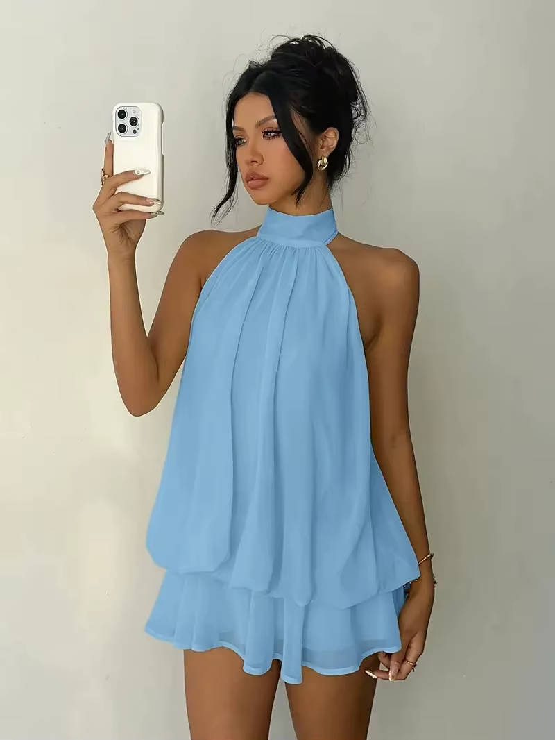 Flowy women's summer mini dress, sleeveless halter neckline, delicate ruffle hem, and a striking open back design.