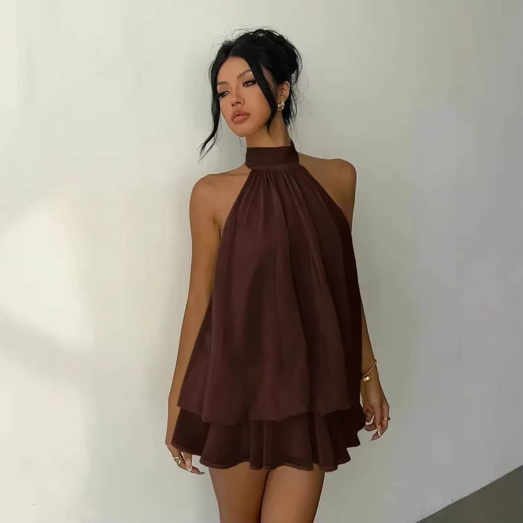 White women's summer party dress, sleeveless halter style with a chic ruffle hem and elegant open back.