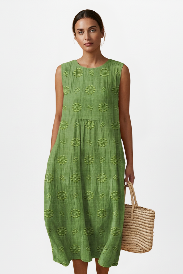 Women's midi dress with pockets, sleeveless & round neck, elegant textured pattern, ideal for summer fashion.