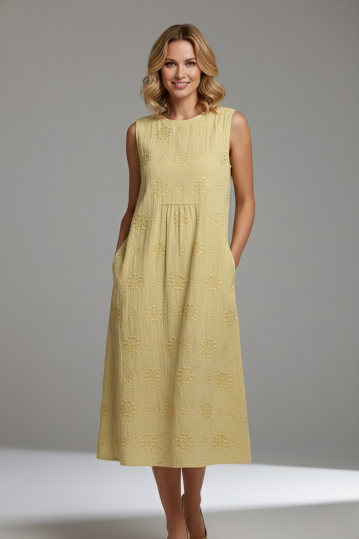 Chic women's spring midi dress, sleeveless round neck, intricate textured pattern, a modern casual style.