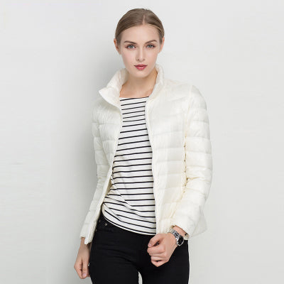 Women's slim fit insulated puffer coat in white, side view, ideal for cold weather, fashionable.