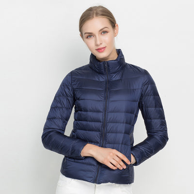 Women's slim fit insulated puffer winter coat in navy blue, open, showcasing interior lining.
