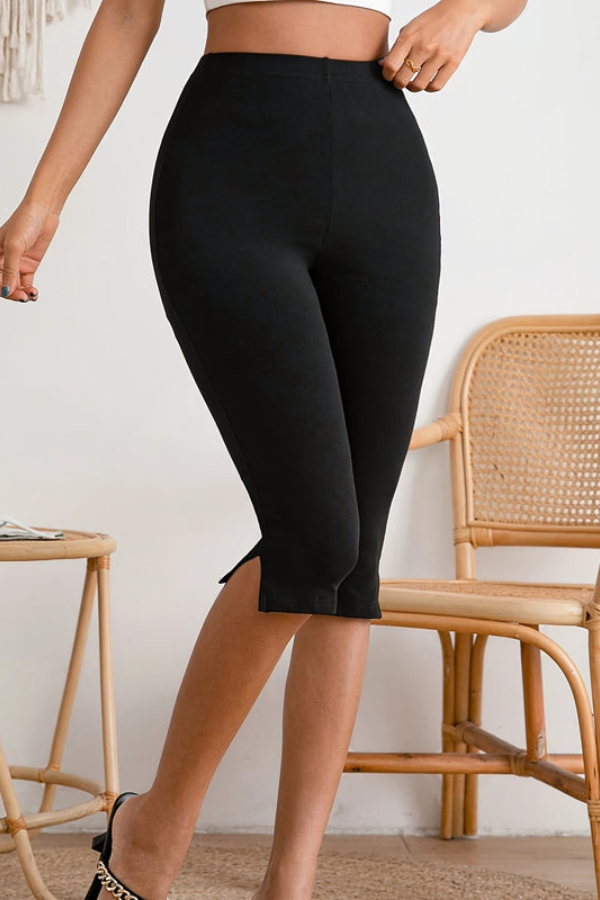 Elegant black women's slim-fit cropped pants with a chic slit hem. Stretch fabric offers all-day comfort & style.