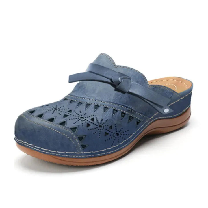 Women's slip-on clogs with bow accent & cutout design. Comfortable, stylish summer footwear.