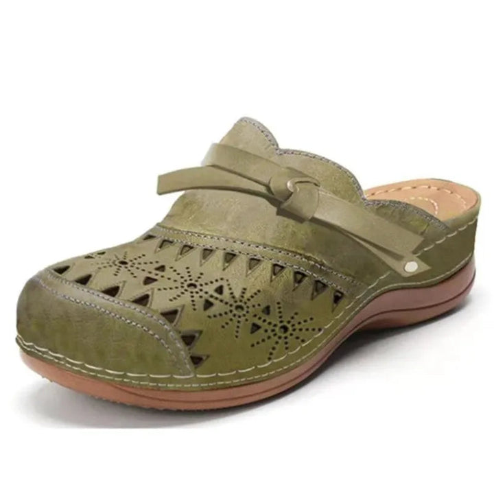 Stylish women's bow accent slip-on clogs. Features trendy cutout details, perfect as summer sandals.