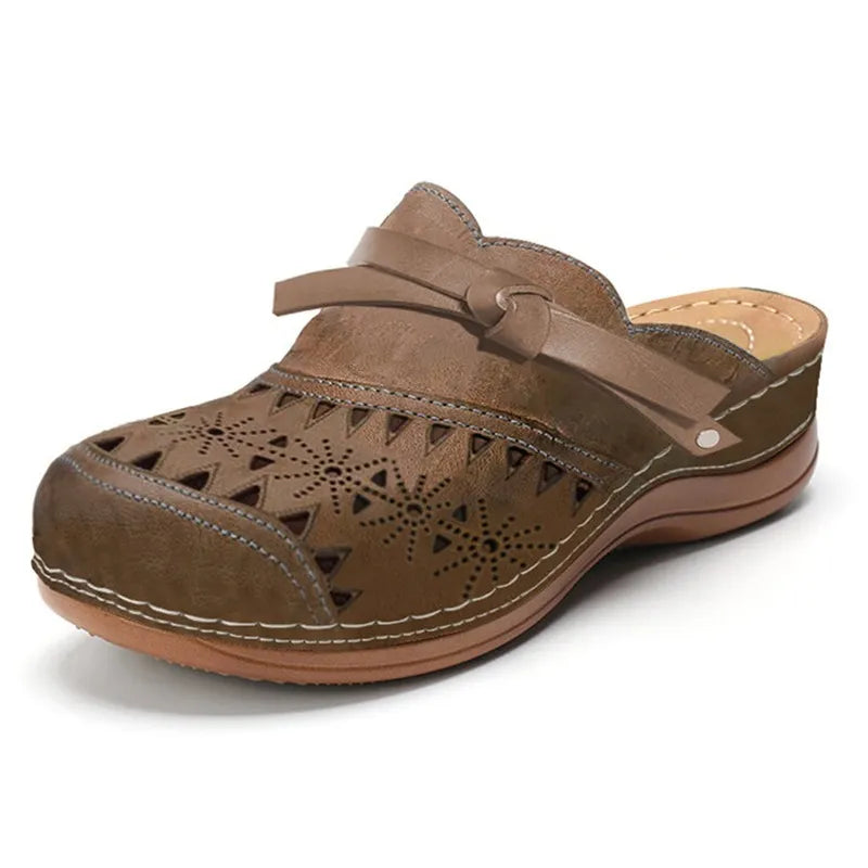 Modern women's cutout clogs with decorative bow. Slip-on design offers easy, comfortable, and stylish summer wear.