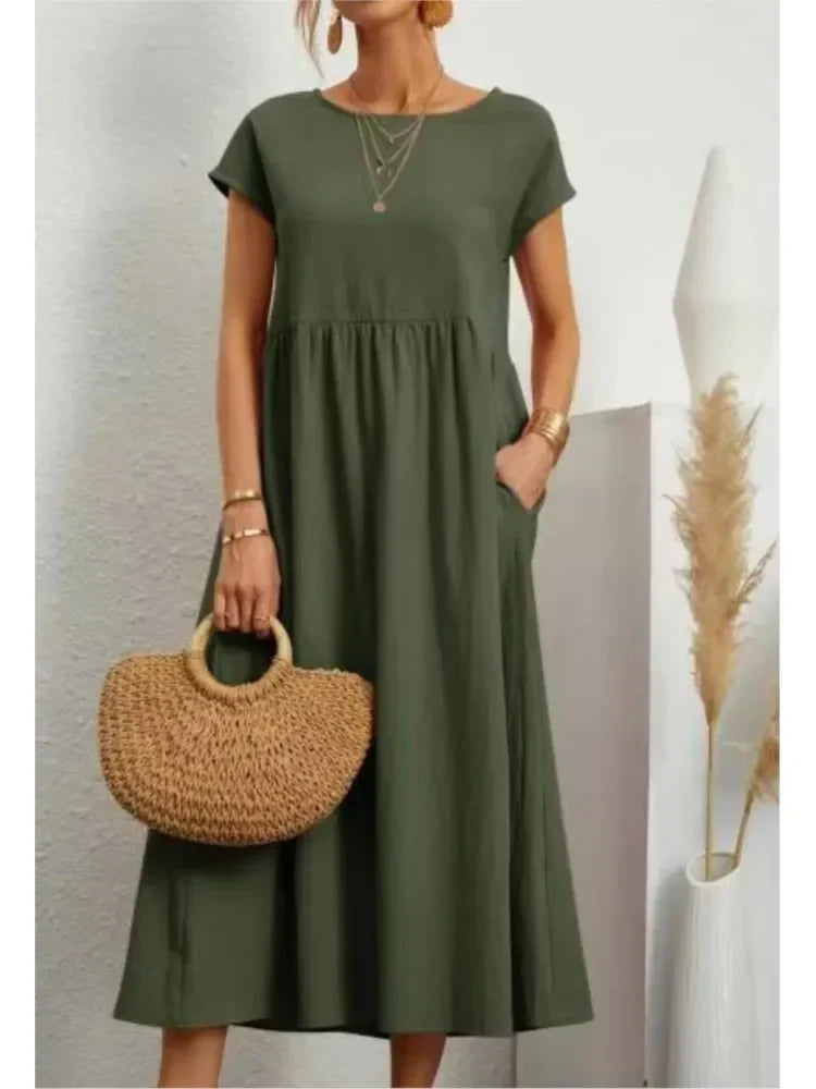 A-line smock waist maxi dress for women, featuring short sleeves and convenient side pockets. Casual fashion.