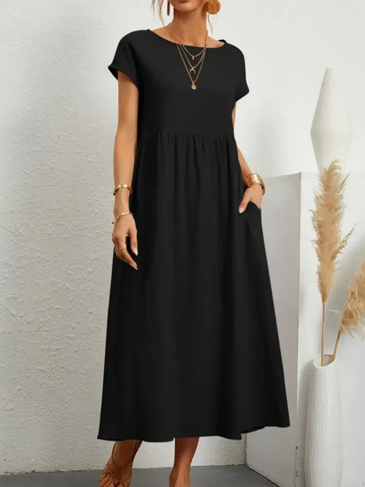 Chic short sleeve smock waist maxi dress for women, A-line cut with pockets, ideal for relaxed summer days.