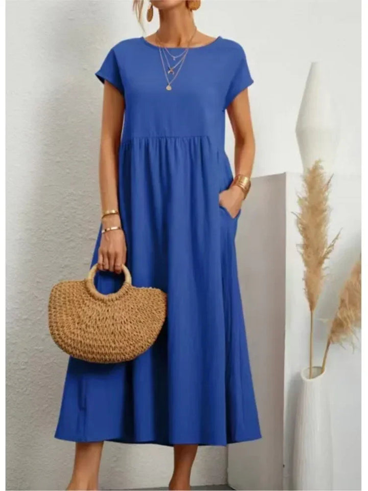 Women's smock waist maxi dress with short sleeves and pockets, casual A-line design for comfortable summer fashion.