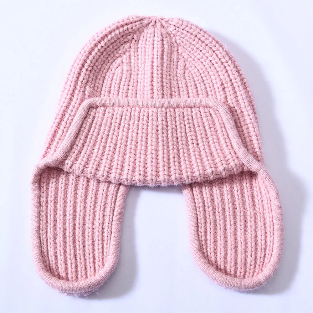 A folded women's cashmere blend beanie, illustrating its compact and travel-friendly design.