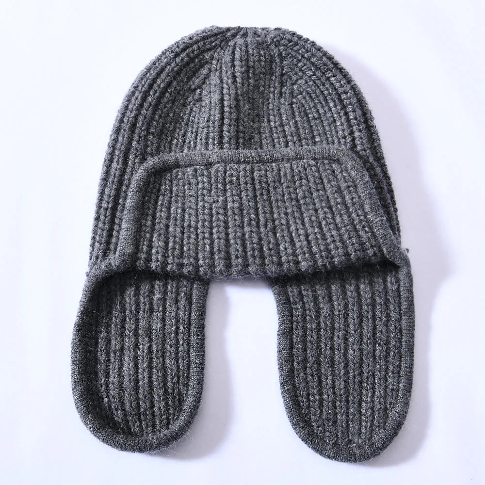 Soft pink cashmere blend beanie, a women's warm hat adding a pop of color to winter outfits.