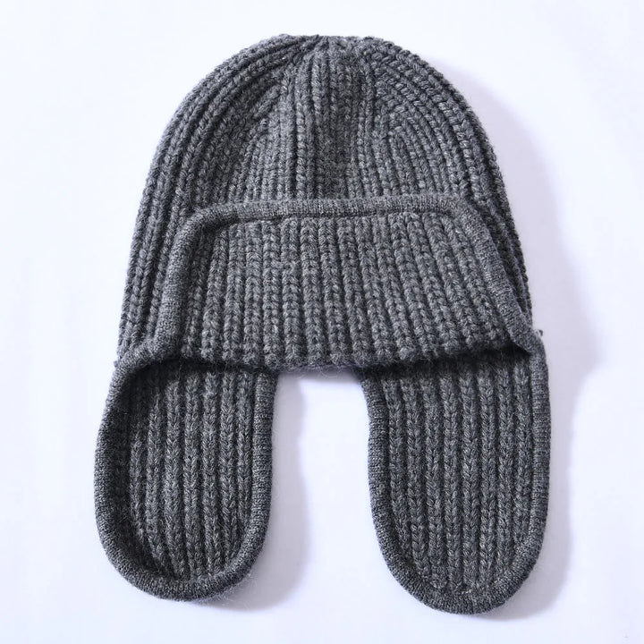 Soft pink cashmere blend beanie, a women's warm hat adding a pop of color to winter outfits.