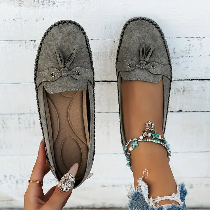 Soft black women's loafers with cushioned insole; classic style for daily wear.