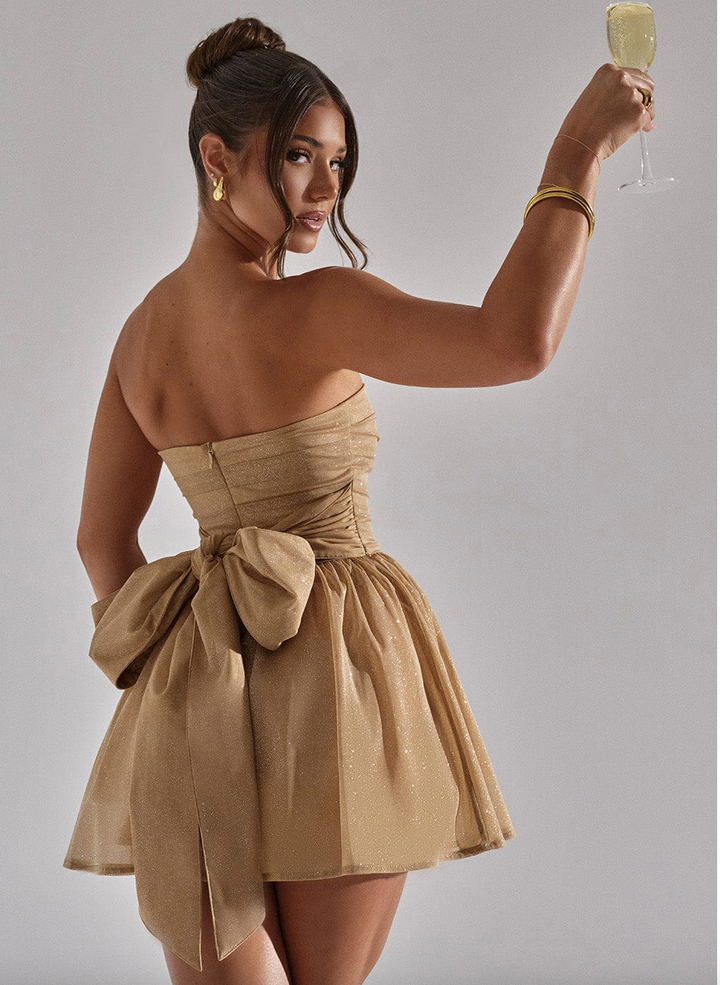 Model wearing a dazzling women's black strapless mini dress, a perfect sparkling party or dance dress.