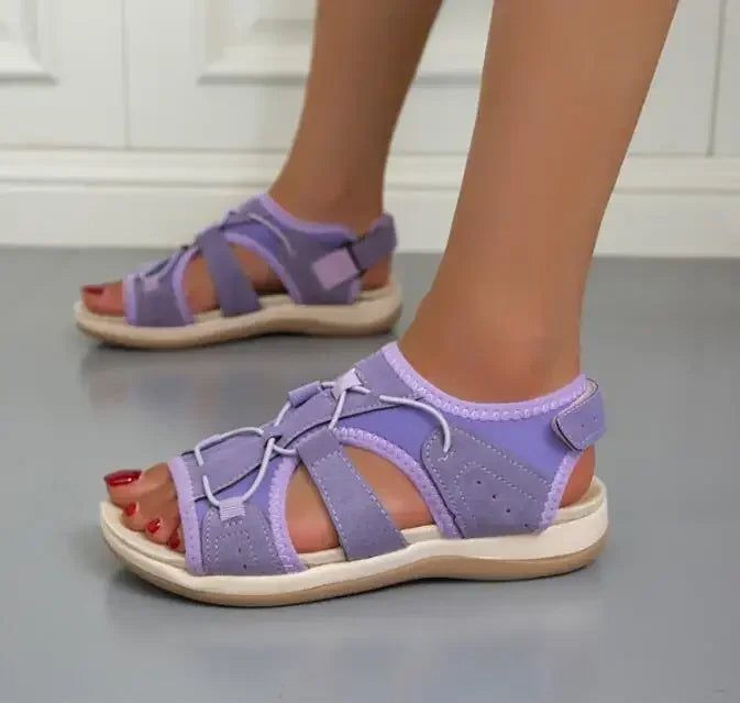 Model wearing women's strappy comfort sandals, demonstrating their relaxed, sporty fashion.