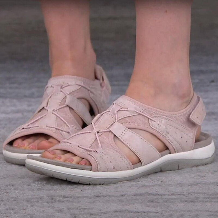 Woman walking in sporty comfort sandals, showcasing their casual and practical footwear appeal.