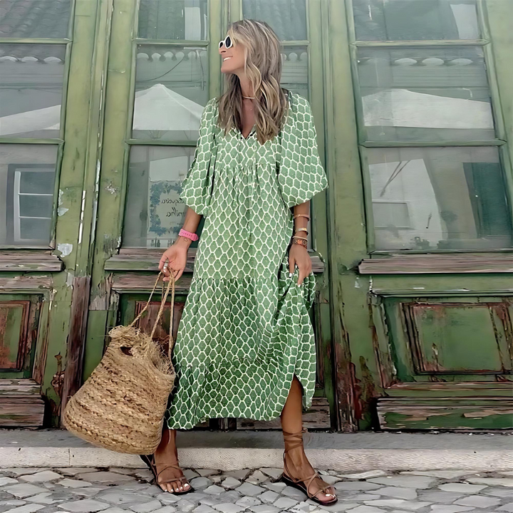 Stylish women's spring patterned maxi dress with long sleeves, flowing silhouette, & flattering V-neck.