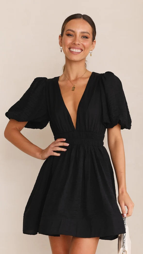 Detailed image of the hemline of a women's 'Spring' puff sleeve mini dress, emphasizing its length.
